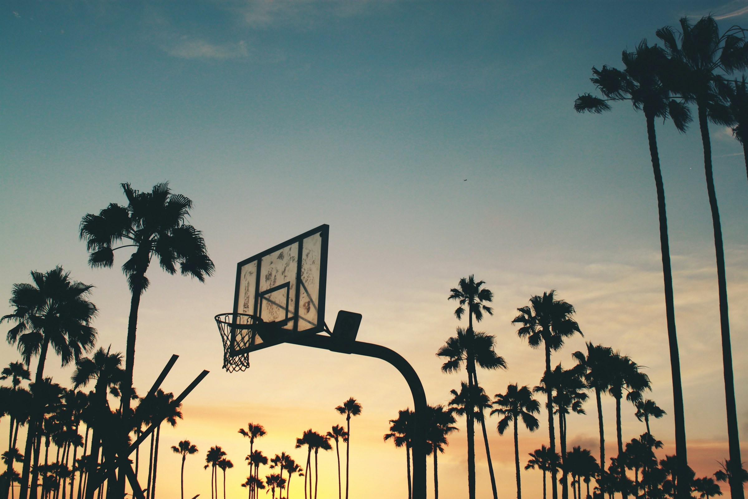 Basketball hoop against a dusk sky