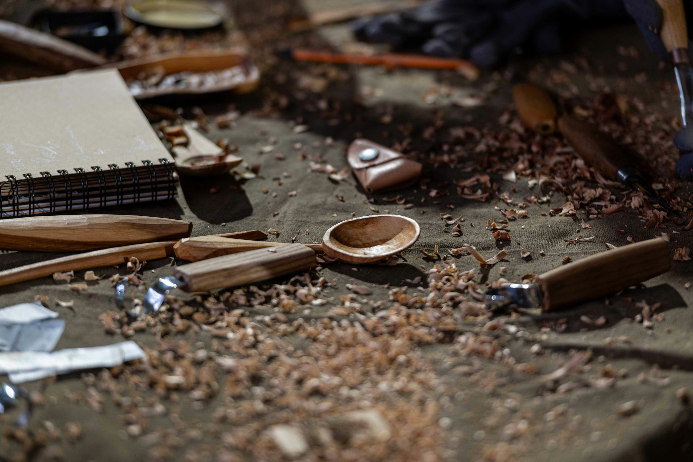 Hand tools and wood shavings on a workbench